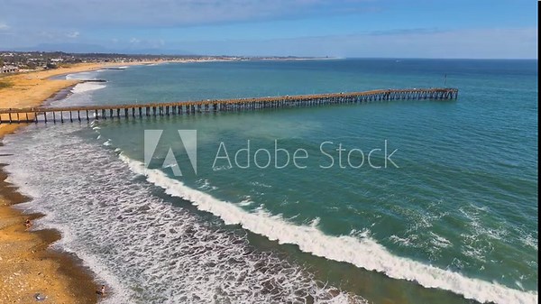 Aerial footage of the Ventura Pier with vast blue ocean water and waves at Ventura beach in Ventura California USA 素材庫影片