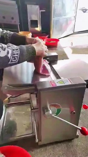 Butcher Demonstrates Meat Slicing Machine Technique