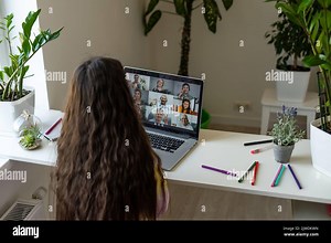 Online training. The teacher teaches the child a video call chat classroom video conferencing. Little girl teach a lesson using a laptop with sitting Stock Photo - Alamy