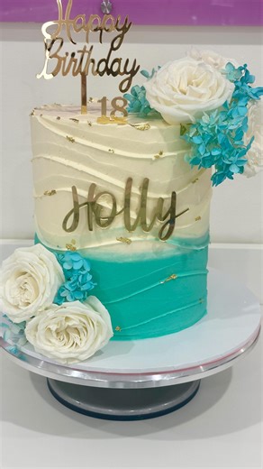 Katrina on Instagram: "✨ Custom Birthday Cake Creation ✨ This elegant 18th birthday cake was such a joy to create 🤍 Featuring soft ivory and teal ombré buttercream, delicate gold leaf accents, and beautiful floral details — all finished with a personalised topper for Holly. Thank you for trusting me to be part of such a special milestone 💫 If you’re celebrating a birthday, milestone, or special occasion, I’d love to create something just as unique for you! 🎂💐 #CakeDecorating #CakeDesign #Omb