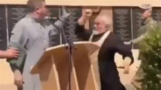 Moment Russian priest hits Ukrainian clergyman with CROSS at troop's funeral