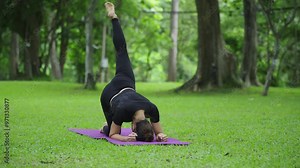 Athletic woman performing one legged dog yoga pose Stock Video