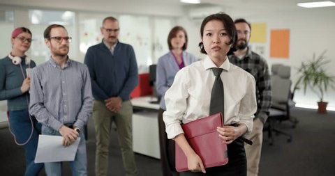 clip-3967625983-group-people-meet-office-setting-review-their