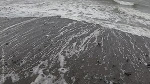 Waves crashing onto the rocky beach of the Ballantrae Coast in Ayrshire, Scotland.