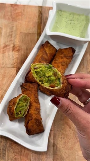 Avocado egg rolls are so good and so easy to make! 2 ripe avocados1/4 cup diced tomato 1/4 cup diced red onion 1 tablespoon chop cilantro1 tablespoon lime juice1 teaspoon salt 1/4 teaspoon pepper12 eggroll wrappersJalapeño sauce:1 seeded deveined jalapeño1/2 cup cilantro 1 clove garlic2 tbs lime juice1/2 tsp salt1/4 tsp pepper1 tbs mayonnaise 1/4 cup sour cream Peel avocados and place in a large bowl and mash with a fork . Add onion tomato cilantro, lime juice, salt, and pepper mix well then pla