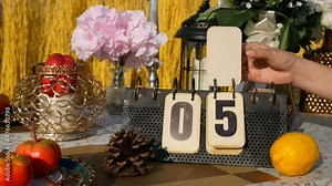 4K footage real time for 10 seconds countdown. hand turning page on flip vintage metal calendar digit number 9 countdown to digit number 0, on the table with party decoration. countdown for new year