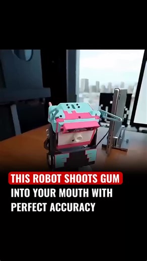 Tech Page on Instagram: "A quirky precision robot that “sh00ts gum into your mouth” uses a camera and fast target-tracking to lock onto a person’s open mouth, a small pneumatic or spring-driven launcher to propel a soft gum pellet, and tiny actuators to aim, all timed so the candy lands gently and accurately. It’s mostly a novelty/demo of vision, timing, and soft-projectile control (think carnival trick meets robotics lab), but it raises obvious safety issues, choking risk, hygiene, and consent,