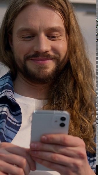Happy smiling Caucasian man sitting on couch at home using mobile phone indoor male relaxed carefree guy scrolling social media apps smartphone laughing enjoying watching web browsing comfortable sofa Stock Video Footage - Alamy