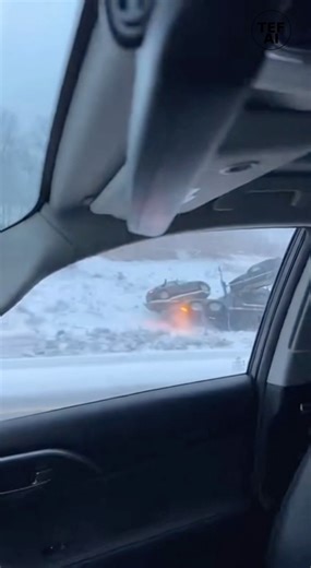SEMI TRANSPORT LOSES CONTROL ON ICY WYOMING HIGHWAY AFTER TIRE ERUPTS 🚛❄️ A dangerous moment unfolded along Interstate 80 near Laramie, Wyoming, when a semi truck hauling multiple vehicles lost control on a snow-covered highway, all captured from a passing dashcam. Video shows the transport truck moving through icy conditions when smoke suddenly begins pouring from one set of tires. Moments later, flames appear — likely caused by overheated brakes or a locked wheel dragging against the frozen p