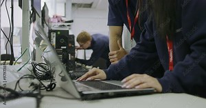 Team of workers in an electronics factory working on computer testing and repair