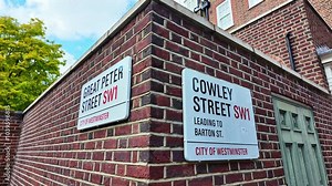 Close-up view from the street sign of Great Peter Street and Cowley Street, London, England.