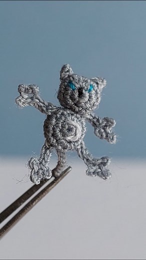 Gray cat with blue eyes and white neon moon on his tummy. #lovecustomorders #luciaknit #microcrochet #microart #microcrochetart #microartist #impossible #nanocrochet #crochet #cat #graycat #crochetcat | LuciaKnit Creative Ideas