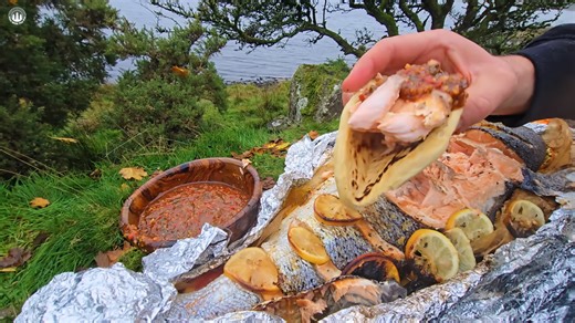 Watch how a whole salmon smokes slowly over open fire