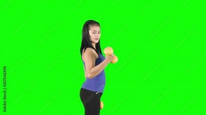 Beautiful woman exercising with dumbbell on studio