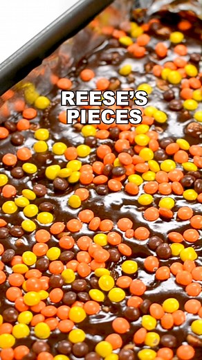 The ULTIMATE Reese’s Brownies! This is a one bowl brownie recipe FULL of 3 KINDS of Reese’s: peanut butter cups, peanut butter chips, and Reese’s Pieces!! The best brownie recipe for peanut butter lovers! https://www.crazyforcrust.com/ultimate-reeses-brownies/ | CrazyforCrust