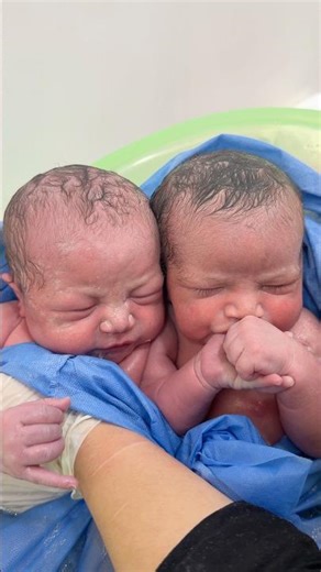 twins baby first bath one of them hungry