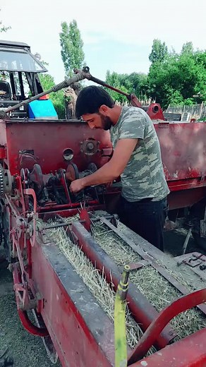 Baling Hay with a Red Agricultural Machine