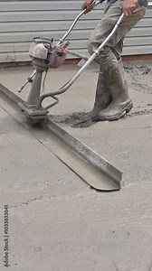 Concrete being tamped with compactor rammer at construction site for foundation