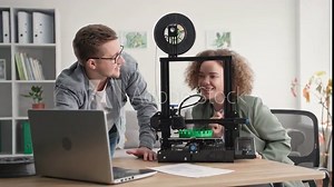 modern technologies, young creative female and male engineers create a prototype of a 3D model at home