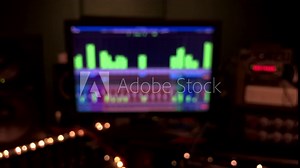 A dark and blurred sound recording studio type background with moving level meters and flickering led lights Stock Video