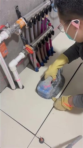 installing beautiful white floor ceramic tile manually using tool