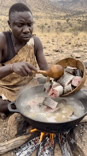 Hadzabe tribe chaba cooking delicious jollof rice inside in the wild
