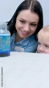 Little scientist. Curious daughter play with mom engaged at education activity make funny experiment. Interested small girl watch elder sister doing chemical test use chemistry set kids