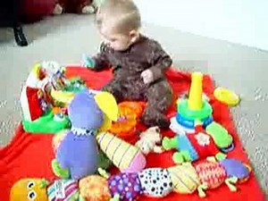 6 month old baby babbling and playing with toys