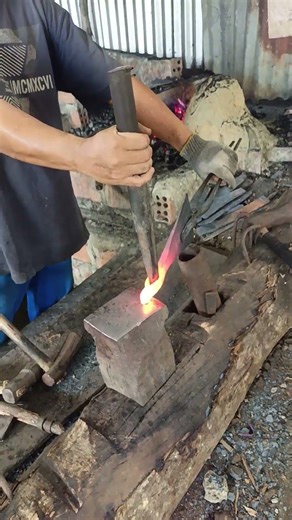 traditional blacksmith making axes to defend wood