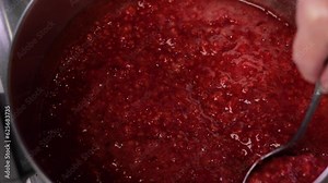 Canning process sequence cooking raspberries and adding sugar to make jam