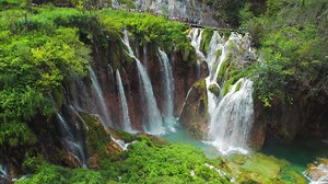 Plitvice Lakes National Park with many waterfalls. Clean water flows from cliffs in cascades. Nature in Croatia.