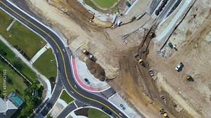 Roundabout construction roadworks on American transport infrastructure. Renovation of highway road with moving traffic. Development of interstate transportation concept.