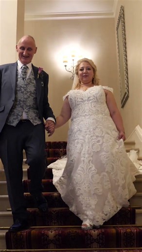 Wedding Couple walk down the stairs