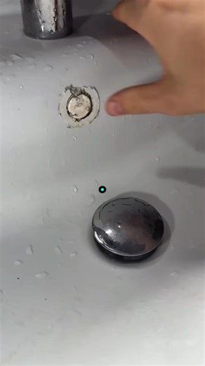 Hey everyone ! Today , we're sealing up this sink drain . You can see the metal pipe here . I'm carefully applying this white sealant all around the base to make sure it's watertight . #plumbing #plumber | Chivornneang1