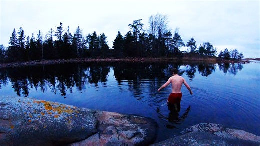Cold sea swim after a coastal hike with a simple tarp shelter build