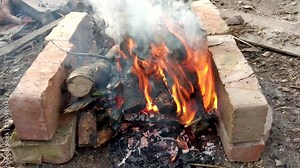 Backdrop of the fire flame and ashes. Bonfire fire texture on wild nature background.