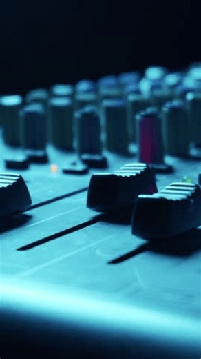 clip-4100720431-close-shot-volume-faders-on-professional-studio