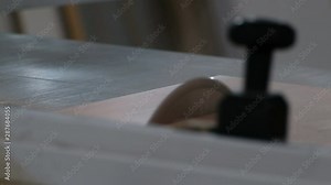 A closeup of a circular saw. Machine for cutting chipboard and other sheet materials. Furniture manufacturing. Video with real sound.