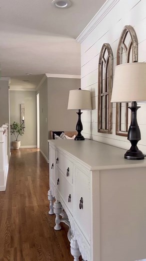 Unintentional spring buffet decorating can be achieved with a few simple items. A pottery vase filled with fresh eucalyptus stems can add a touch of natural beauty and fragrance to the table. Wood candle holders can create a warm and inviting ambiance, while woven baskets add texture and a touch of rustic charm. For symmetry, black lamps can be placed on each end of the buffet, creating a balanced and cohesive look. Overall, this combination of elements can create a charming and effortless sprin