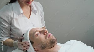 Female doctor exam person skin. Male patient consultation. Dermatology aesthetic surgery preparation. Spa salon facial treatment video. Luxury hospital check. Rejuvenation touch. Hands in gloves