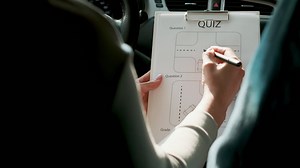 Free stock video - Woman doing quiz on driving school