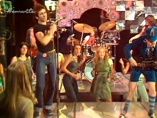 We’re starting our exploration of Australian music TV in the stratosphere – with AC/DC in their 1976 heyday. Nine Network’s ‘Bandstand’ had just been revived after a four-year break and was ready to go head-to-head with ‘Countdown’. Its opening episode featured the legendary rockers singing ‘It’s a Long Way to the Top (If You Wanna Rock ‘n’ Roll)’, surrounded by adoring teenagers in flutter sleeves and double denim. ‘Bandstand’, like ‘Countdown’, attempted to capture the impact of live performan