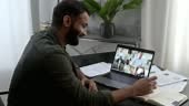 Successful indian man using a laptop, conducts virtual meeting with...