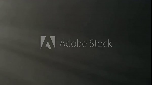 Spotlight beams illuminates gray cloud of smoke, fog in the dark. Clouding smoke on black background. Effective texture of vapor, fog, smoke. Slow motion.