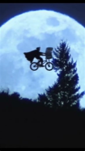 ET the extraterrestrial flying bicycle over the moon scene