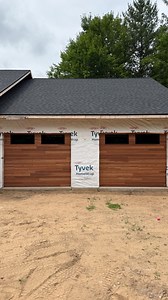 20K views · 290 reactions | Cedar plank-style garage doors with black window trim went in last week. Had my daughter along for the install too! Hoping to swing back once the siding’s done to grab some finished shots. #garagedoors #northwoods #wisconsin | Caged Crow Fabrication | Facebook