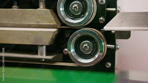 conveyor belt the process of packing coffee beans sealing the packaging in coffee production mechanisms close-up