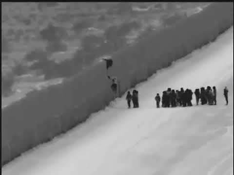 Watch as migrants use ladder to cross border fence in Arizona