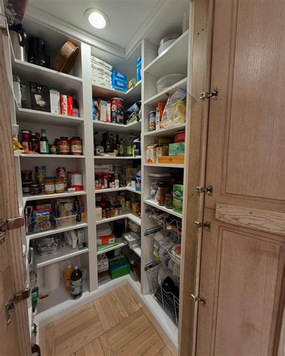 Check out this secret walk-in pantry hidden in the kitchen! Plenty of roomy shelving and low-reach wire baskets 🧅🥫🍞 Is this the pantry you've been looking for? Let us know in the comments! #ClosetsbyDesign #HomeOrganizers #CustomStorage #Declutter #LoveYourHome #Pantry #PantryGoals #PantryRedesign | Closets By Design