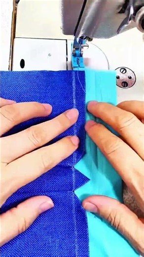 Blue fabric guides needle stitches binding strip steady